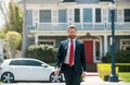 Real estate agent welcoming visitors near new house. Portrait of realtor man. Royalty Free Stock Photo