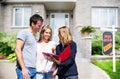 Real Estate agent woman with clients near new house. Royalty Free Stock Photo