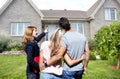 Real Estate agent woman with clients near new house. Royalty Free Stock Photo