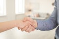 Real estate agent and young man shaking hands indoors Royalty Free Stock Photo