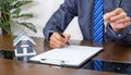 Real estate agents hand use pen explains the business contract for signing a business contract, renting, buying, mortgage, loan or