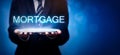 Real estate agents offer the word mortgage. Property mortgage concept Royalty Free Stock Photo