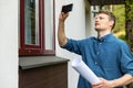 Real estate appraiser taking pictures of property with phone Royalty Free Stock Photo