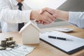 Real estate broker agent and customer shaking hands after signin Royalty Free Stock Photo