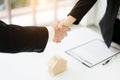 Real estate broker and customer shaking hands after signing a contract: real estate, home loan and insurance concept Royalty Free Stock Photo