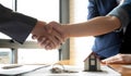 Real estate broker and customer shaking hands after signing a contract: real estate, home loan and insurance concept Royalty Free Stock Photo