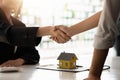 Real estate broker and customer shaking hands after signing a contract: real estate, home loan and insurance concept Royalty Free Stock Photo
