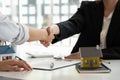 Real estate broker and customer shaking hands after signing a contract: real estate, home loan and insurance concept Royalty Free Stock Photo