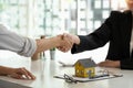 Real estate broker and customer shaking hands after signing a contract: real estate, home loan and insurance concept Royalty Free Stock Photo