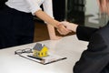 Real estate broker and customer shaking hands after signing a contract: real estate, home loan and insurance concept Royalty Free Stock Photo