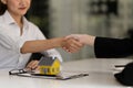 Real estate broker and customer shaking hands after signing a contract: real estate, home loan and insurance concept Royalty Free Stock Photo