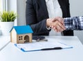 Real estate broker shaking hands with customer after signing agreement contract Royalty Free Stock Photo