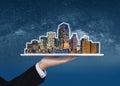 Real estate business, building technology and smart city. Businessman hand holding digital tablet with buildings hologram Royalty Free Stock Photo