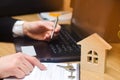real estate buying an apartment. Real estate agent putting signing contract, sitting at the computer. moving home or renting prop