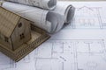 Real Estate concept. Architect workplace. Architectural project, blueprints, blueprint rolls and model house on plans Royalty Free Stock Photo