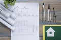 Real Estate concept. Architectural project, blueprints, blueprint rolls and divider compass on vintage wooden table Royalty Free Stock Photo