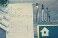 Real Estate concept. Architectural project, blueprints, blueprint rolls and divider compass on vintage wooden table Royalty Free Stock Photo