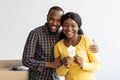 Real Estate Concept. Happy African American Spouses Holding Paper House Figure Royalty Free Stock Photo