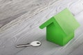 Real estate concept, house and key on wooden background. Idea for real estate concept, personal property and family house, ecolog Royalty Free Stock Photo