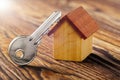 Real estate concept with house and key on wooden background. Idea for real estate concept, personal property an Royalty Free Stock Photo