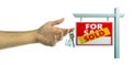 Real estate,  concept. Man holding house keys, blur sold for sale sign, white background. 3d illustration Royalty Free Stock Photo