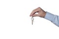 Real estate concept: man`s hand holding keys isolated on white background with clipping path  included and copy space for your te Royalty Free Stock Photo