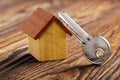 Real estate concept with small toy wooden house and key on wooden background. Idea for real estate concept, personal property an Royalty Free Stock Photo