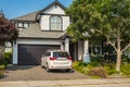 Real Estate Exterior Front House. Big modern custom house front yard and driveway to garage on a sunny summer day Royalty Free Stock Photo