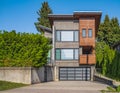 Real Estate Exterior Front House on a sunny day. Big custom made luxury house with nicely landscaped front yard