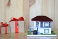 Real estate and Gift new home concept,Model house and Gift box on wooder background Royalty Free Stock Photo