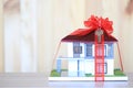 Real estate and Gift new home concept,Model house with Red ribbon and key on wooder background Royalty Free Stock Photo
