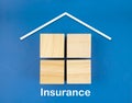 The Real Estate icons on wooden blocks on blue background. Home Insurance concepts Royalty Free Stock Photo