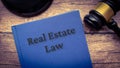 Real estate law book and gavel on wooden table. Royalty Free Stock Photo