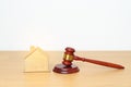 Real Estate Law, Home Insurance, property Tax, Auction and Bidding concepts. small toy house model with gavel justice hammer on Royalty Free Stock Photo