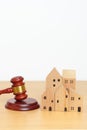 Real Estate Law, Home Insurance, property Tax, Auction and Bidding concepts. small toy house model with gavel justice hammer on Royalty Free Stock Photo