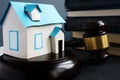 Real estate law. Model of house, gavel and books. Royalty Free Stock Photo