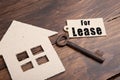 real estate lease concept - old key with tag and cardboard house Royalty Free Stock Photo