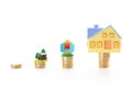 Real estate mortgage concept with plastic house models on top of stacked coins Royalty Free Stock Photo