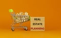 Real estate planning symbol. Wooden blocks, words `Real estate planning` on beautiful orange background. Shopping cart, miniatur Royalty Free Stock Photo