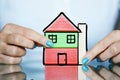 Real estate project with colorful wooden cubes as a house in woman hands Royalty Free Stock Photo