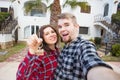 Real estate and property concept - Happy couple holding keys to new home and house miniature Royalty Free Stock Photo