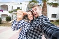 Real estate and property concept - Happy couple holding keys to new home and house miniature Royalty Free Stock Photo