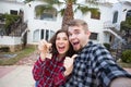 Real estate and property concept - Happy couple holding keys to new home and house miniature Royalty Free Stock Photo