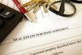 Real estate purchase agreement for filling with pen calculator keys and glasses Royalty Free Stock Photo