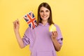 Real estate purchase in Great Britain, immigration. Woman holding British flag and paper house.