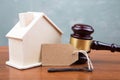 Real estate sale auction concept - gavel and house model on the wooden table Royalty Free Stock Photo