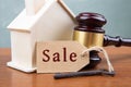 Real estate sale auction concept - gavel and house model on the wooden table Royalty Free Stock Photo