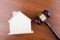 Real estate sale auction concept - gavel and house model on the wooden table