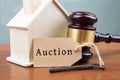 Real estate sale auction concept - gavel and house model on the wooden table Royalty Free Stock Photo