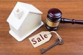Real estate sale auction concept - gavel and house model on the wooden table Royalty Free Stock Photo